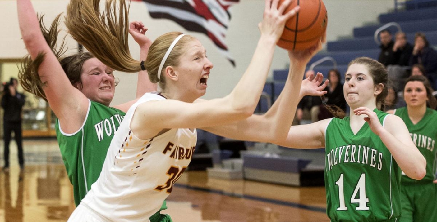 girl shooting basketball