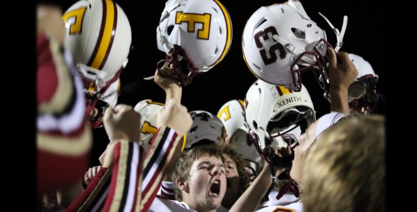 Players holding up helmets