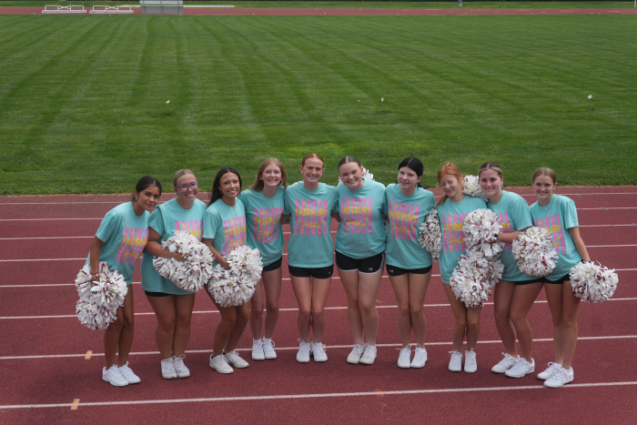 cheerleaders pose for a picture