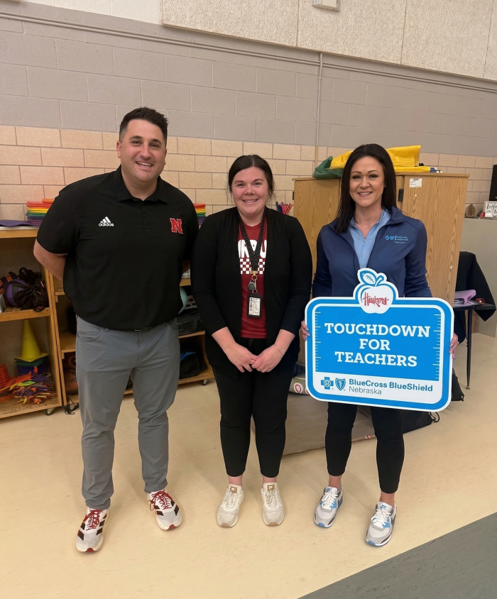 teacher with the two presenters of the award