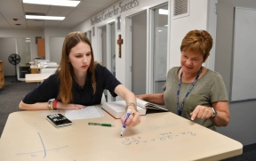 teacher tutoring math student